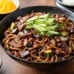 Korean jajangmyeon noodles coated in glossy black bean sauce with pork and vegetables.