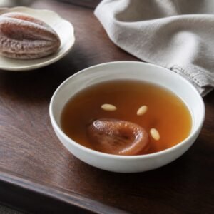 Korean sujeonggwa cinnamon-ginger punch with dried persimmon and pine nuts.