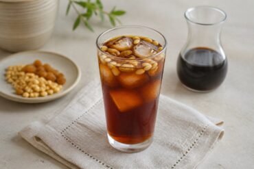 Chilled Lebanese jallab with ice, pine nuts, and golden raisins.