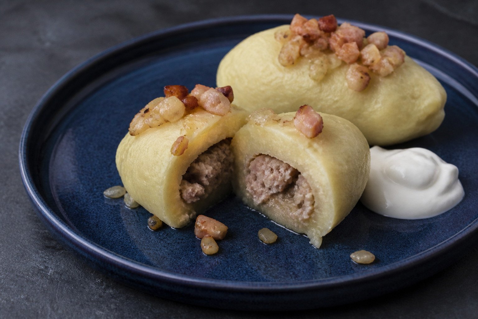 A Lithuanian cepelinas cut open to show its pork filling.