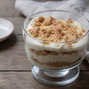 Macanese serradura layered with soft cream and fine biscuit crumbs in a glass.