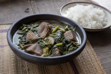 Malagasy romazava beef and leafy-greens stew served with white rice.