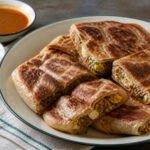Malaysian murtabak filled with spiced beef, egg, onion, and scallions.