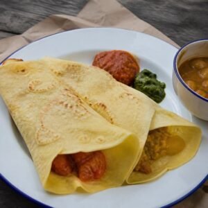 Mauritian dholl puri served with butter bean curry, rougaille, and chutney.