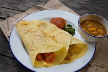 Mauritian dholl puri served with butter bean curry, rougaille, and chutney.
