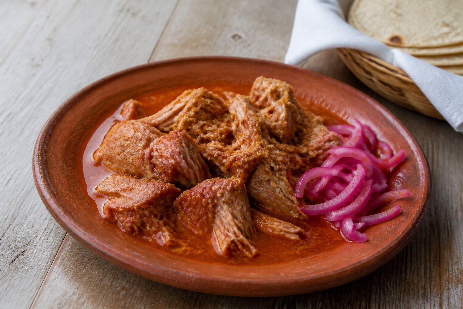 Yucatan cochinita pibil with pickled red onions and warm corn tortillas.