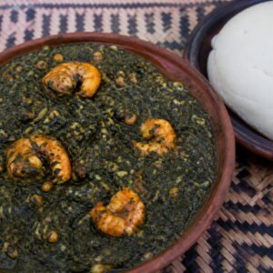 Mozambican matapa with shrimp served beside white xima.