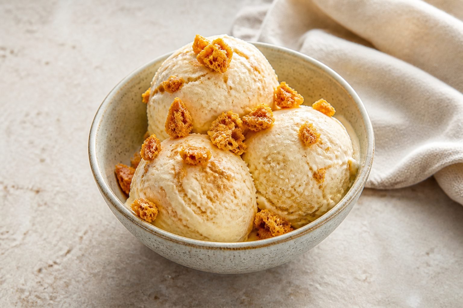 Vanilla hokey pokey ice cream topped with crisp golden honeycomb toffee pieces.
