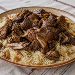 Omani shuwa served over spiced long-grain rice.