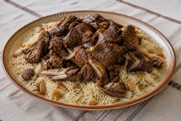 Omani shuwa served over spiced long-grain rice.