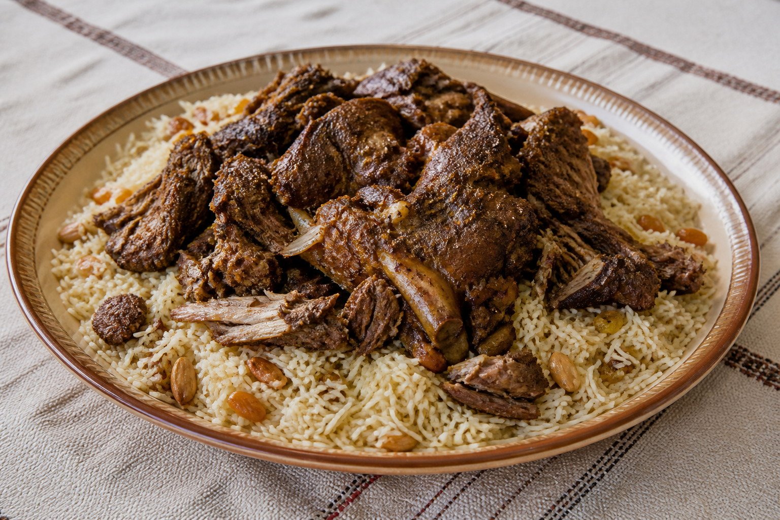 Omani shuwa served over spiced long-grain rice.