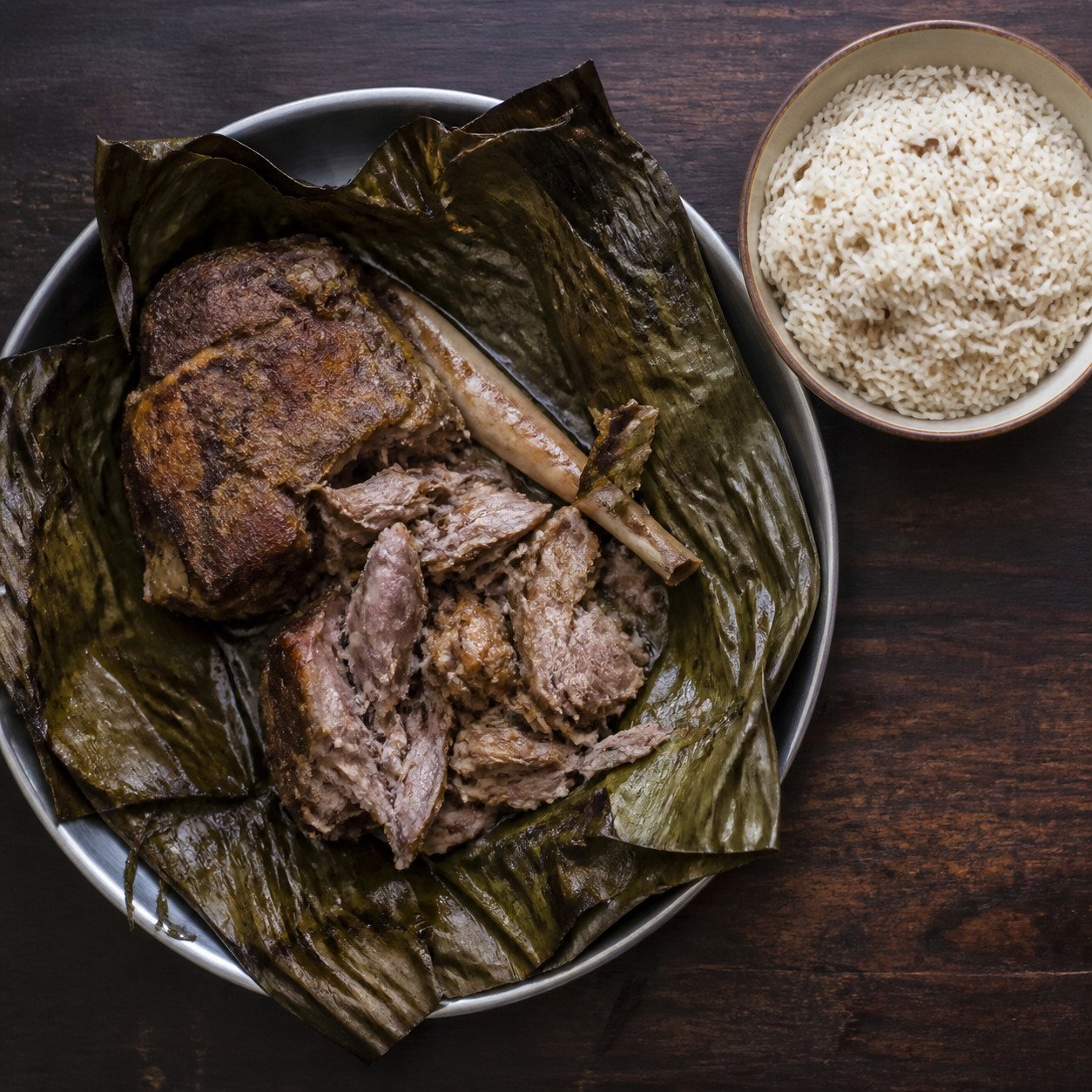 Slow-roasted Omani shuwa opened from its leaf-lined parcel.