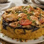 Palestinian maqluba with chicken, eggplant, rice, tomatoes, and toasted almonds.