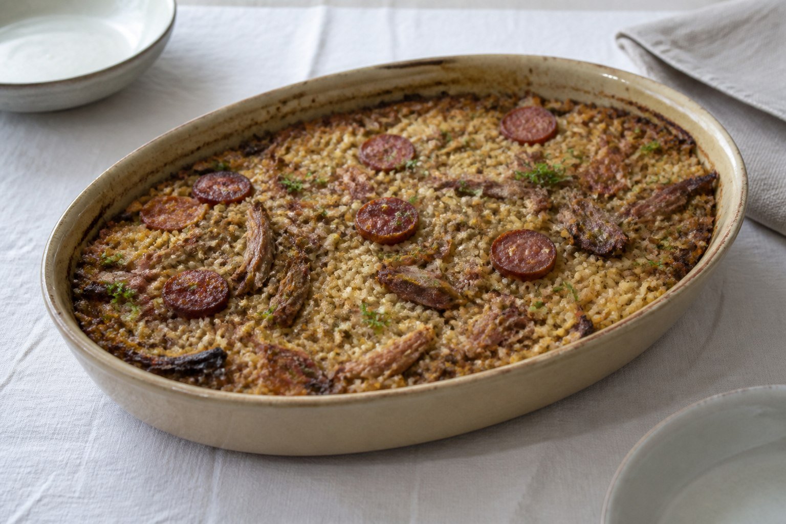Portuguese arroz de pato baked with shredded duck, rice, chourico, and parsley.