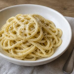 Roman cacio e pepe with tonnarelli, Pecorino Romano, and black pepper.