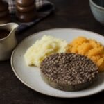 Scottish haggis served with mashed neeps, tatties, and gravy.