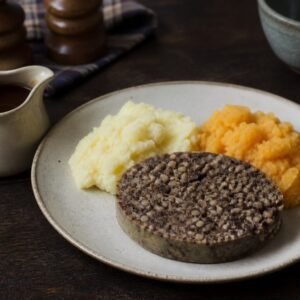Scottish haggis served with mashed neeps, tatties, and gravy.