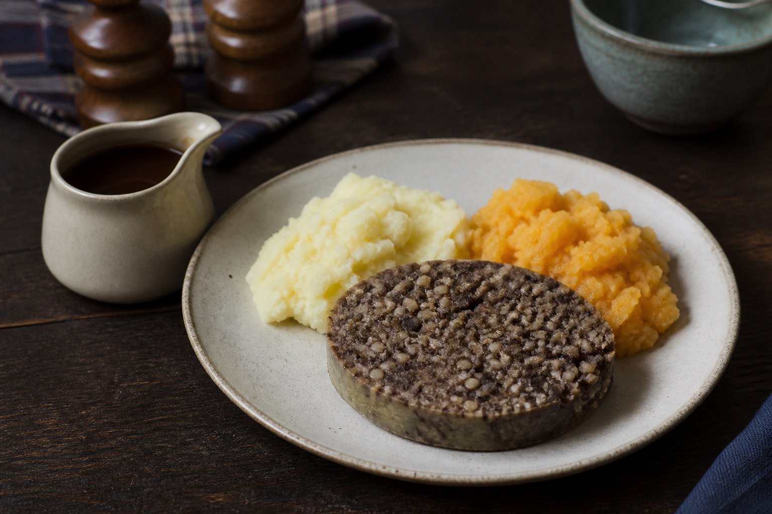 Scottish haggis served with mashed neeps, tatties, and gravy.
