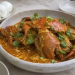 Singapore chili crab in tomato-chili egg sauce with steamed mantou.