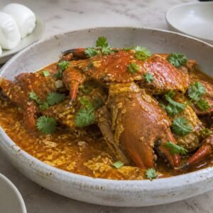 Singapore chili crab in tomato-chili egg sauce with steamed mantou.