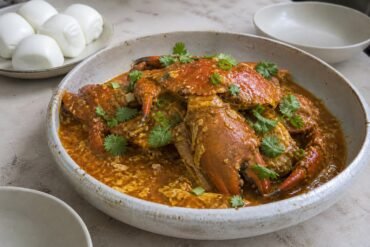 Singapore chili crab in tomato-chili egg sauce with steamed mantou.