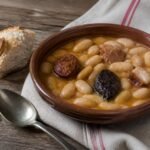 Spanish fabada asturiana with white beans, chorizo, morcilla, and pork.