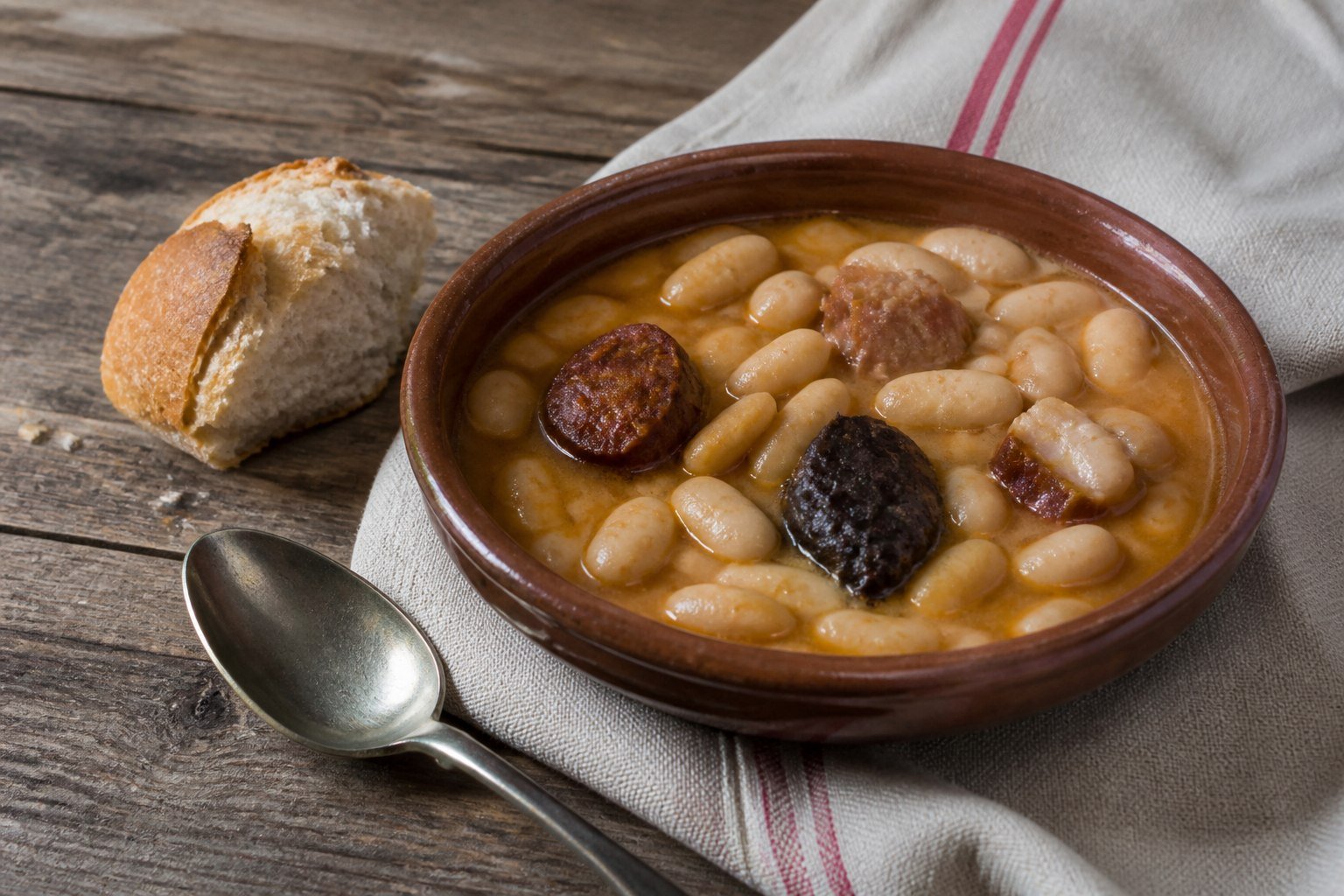 Spanish fabada asturiana with white beans, chorizo, morcilla, and pork.