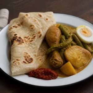 Surinamese chicken roti with masala chicken, potatoes, long beans, egg, and sambal.