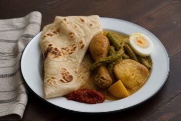 Surinamese chicken roti with masala chicken, potatoes, long beans, egg, and sambal.