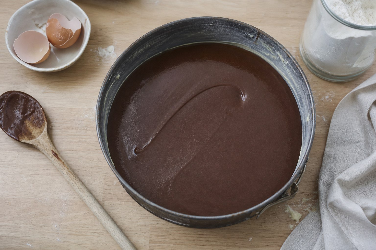 Smooth chocolate kladdkaka batter in a springform pan before baking.