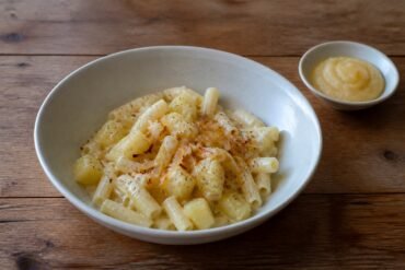 Swiss Älplermagronen with macaroni, potatoes, caramelized onions, and apple compote.