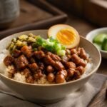 Taiwanese lu rou fan with glossy braised pork, rice, a soy-braised egg, and greens.