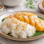 Thai Mango Sticky Rice with ripe mango, coconut sauce, and toasted mung beans.