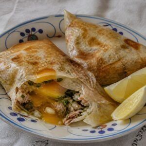 Tunisian brik pastries filled with soft egg, tuna, herbs, and capers.