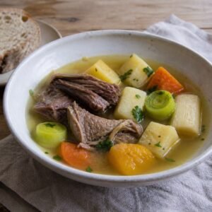 Welsh cawl with tender lamb, leeks, potatoes, carrots, parsnips, swede, and rustic bread.