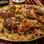 Yemeni mandi with roasted chicken, fragrant rice, raisins, toasted almonds, and herbs.