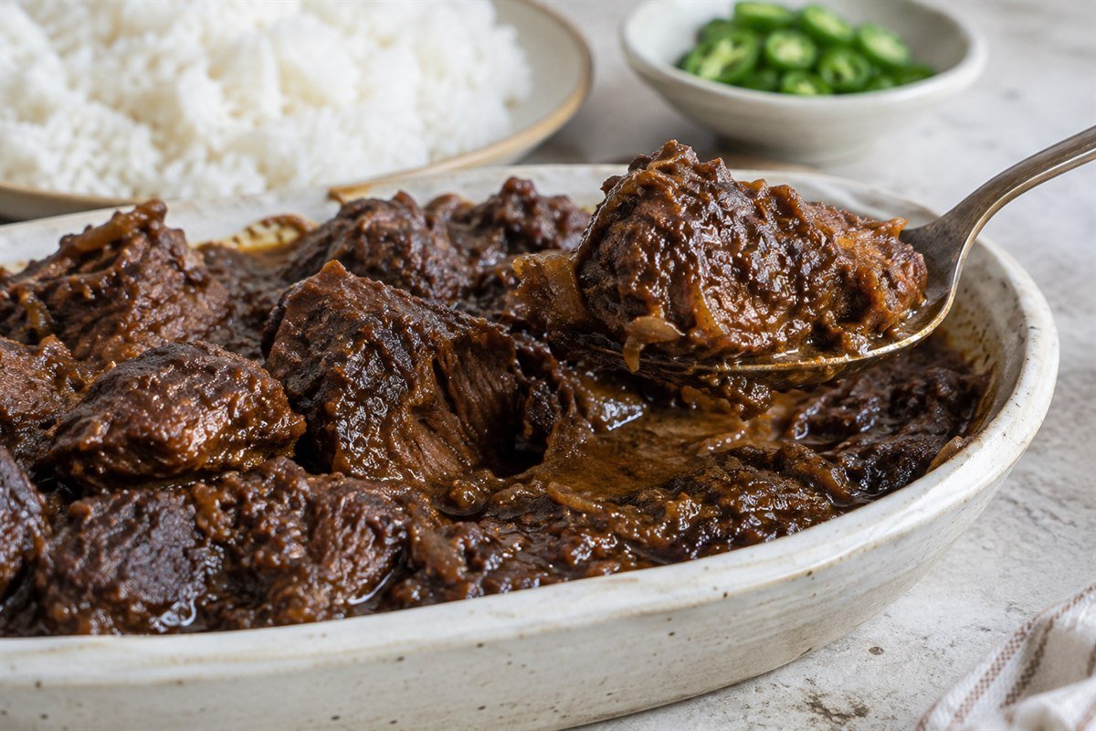 A serving of Bangladeshi kala bhuna with tender beef and reduced onion-spice sauce.