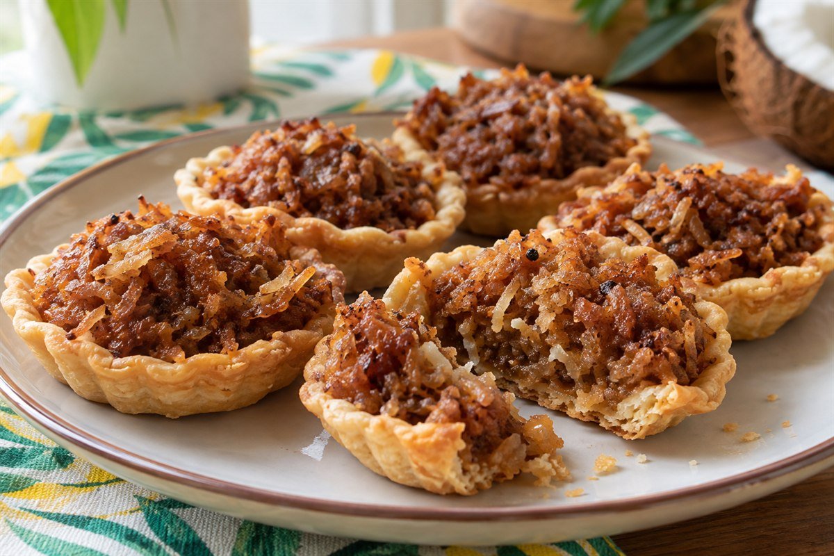 Jamaican gizzada coconut tarts with golden pastry shells and spiced filling.